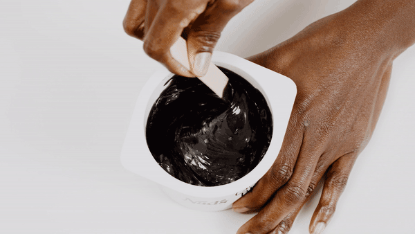 Woman stirring Nad's Bead Wax